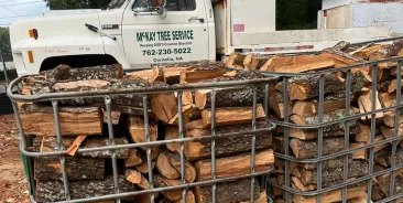Stacked bagged firewood delivered by McKay Tree Service in Cornelia, GA, seasoned hardwood ready to burn for fireplaces and outdoor use.